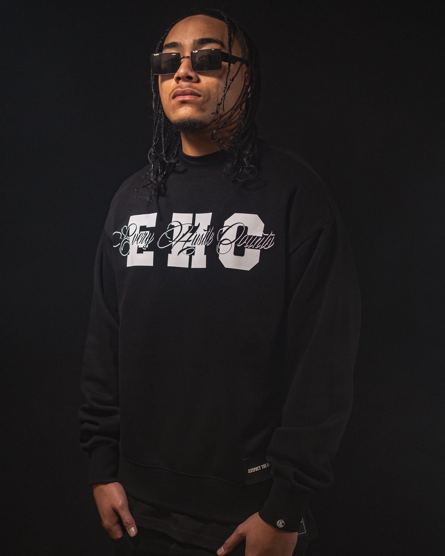 Model wearing the Every Hustle Counts EHC College Script black crew neck sweatshirt