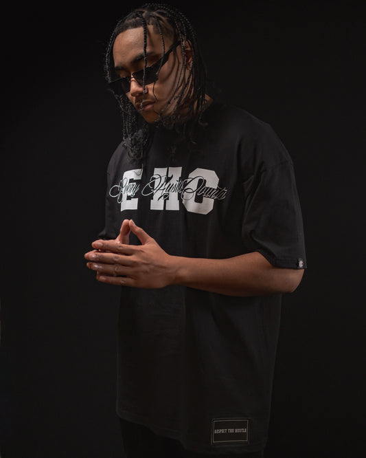 Model wearing the Every Hustle Counts EHC College Script black t-shirt