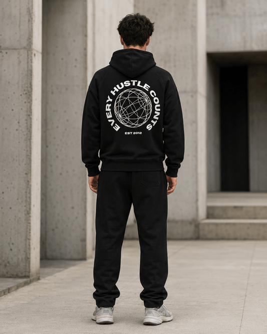Model wearing the Every Hustle Counts EHC World black hoodie, back view showing globe print