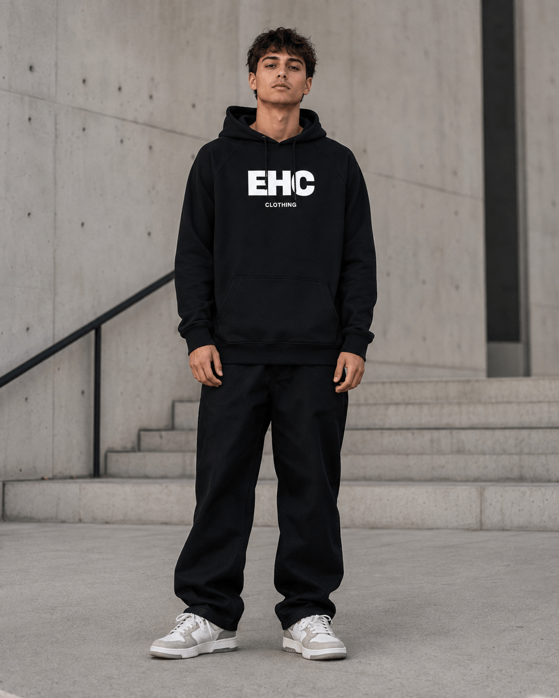 Model wearing the Every Hustle Counts EHC World black hoodie and track pants, front view