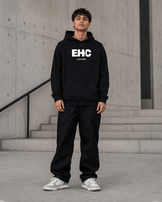 Model wearing the Every Hustle Counts EHC World black hoodie and track pants, front view