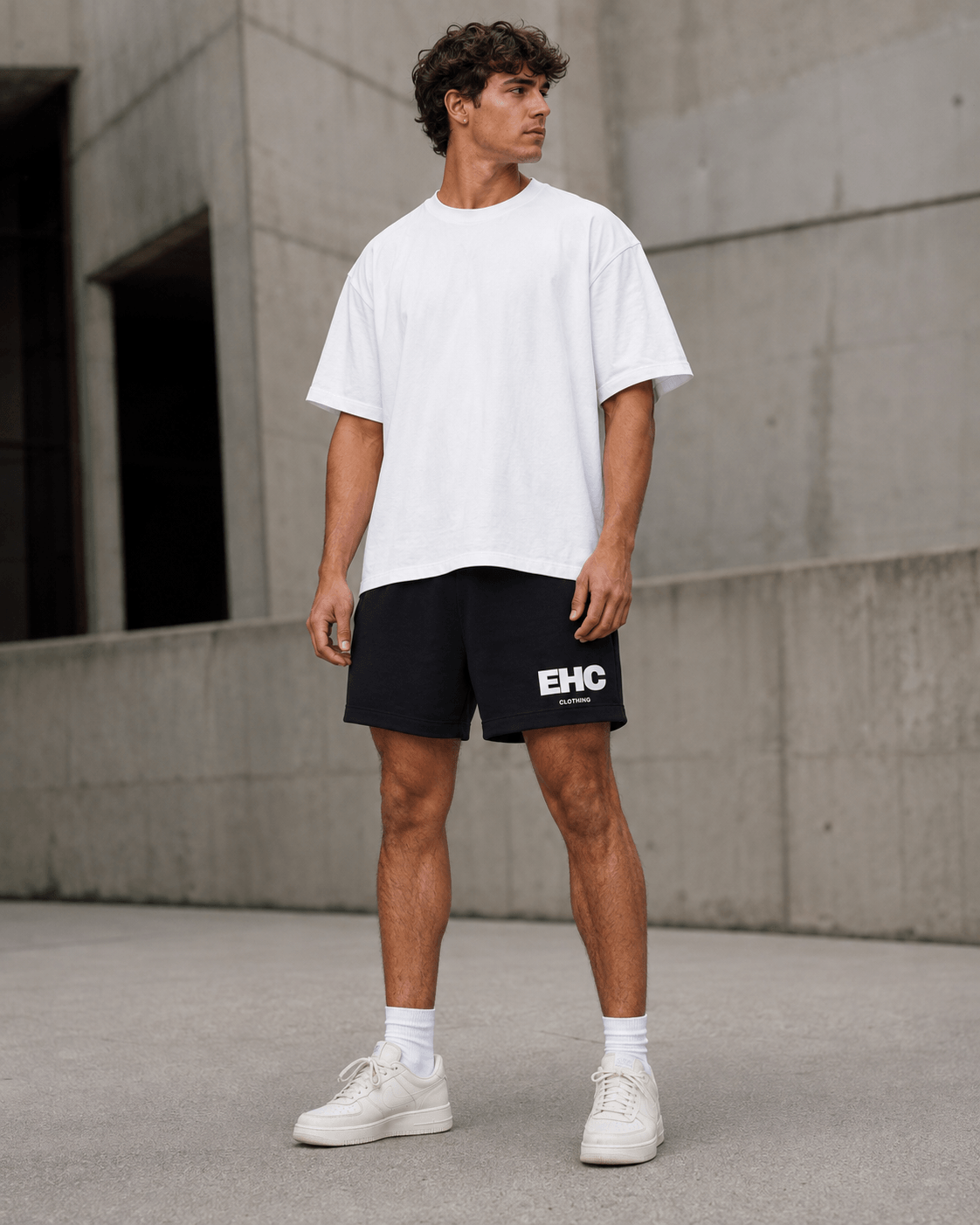 Model wearing the Every Hustle Counts EHC World black shorts with a white tee