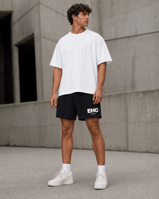 Model wearing the Every Hustle Counts EHC World black shorts with a white tee