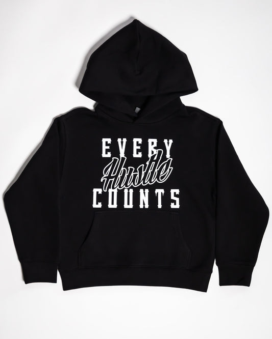 Every Hustle Counts black kids hoodie with white script chest print, flat lay