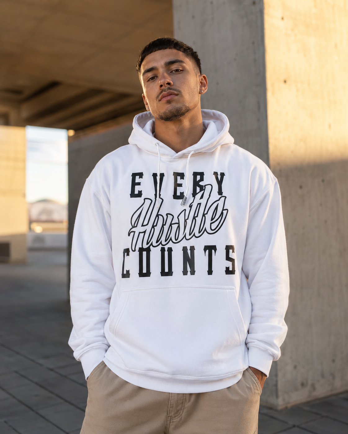 Model wearing the Every Hustle Counts White OG EHC white hoodie outdoors
